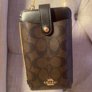 Coach Adjustable Leather Crossbody Phone Holder and Wallet with gold hardware.